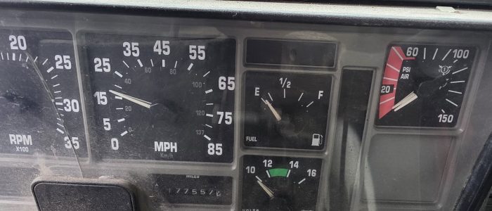 Dash view of hook truck for sale. Odometer reading is 177557.